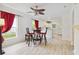 Dining area with wood-look floors, bright white walls, and a view into the kitchen at 2303 28Th E Ave, Palmetto, FL 34221