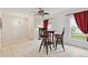 Bright dining area with white walls, wood-look floors, modern ceiling fan, and natural light at 2303 28Th E Ave, Palmetto, FL 34221