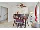 Bright dining area with a ceiling fan, white walls, wood-look floors, and stairs to the left at 2303 28Th E Ave, Palmetto, FL 34221