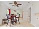 Dining area adjacent to a white kitchen, featuring modern wood-look floors and contemporary lighting at 2303 28Th E Ave, Palmetto, FL 34221