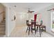 An open dining area featuring wood-look floors, a ceiling fan, and stairs to the side at 2303 28Th E Ave, Palmetto, FL 34221