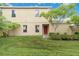 Charming two-story home with a lush front lawn and mature trees enhancing the property's curb appeal at 2303 28Th E Ave, Palmetto, FL 34221