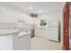Bright kitchen with white cabinets, stainless steel appliances, and tile flooring at 2303 28Th E Ave, Palmetto, FL 34221