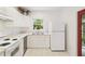 Bright kitchen with white cabinets, stainless steel appliances, and tile flooring at 2303 28Th E Ave, Palmetto, FL 34221