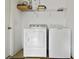 Laundry room includes a washing machine and dryer with shelving for storage at 2303 28Th E Ave, Palmetto, FL 34221