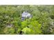 A serene aerial view of a home nestled among trees with a small pond nearby at 25640 State Road 70 E, Myakka City, FL 34251
