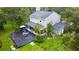 Aerial view of a home with a spacious deck, screened in porch, and lush green yard at 25640 State Road 70 E, Myakka City, FL 34251