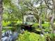 A charming backyard featuring a tranquil pond with a fountain, inviting chairs, and lush foliage at 25640 State Road 70 E, Myakka City, FL 34251