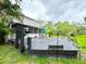 Large wooden deck in backyard featuring outdoor seating, greenery, and a grill at 25640 State Road 70 E, Myakka City, FL 34251