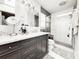 Modern bathroom features a double sink vanity with marble countertop and glass enclosed shower with tile surround at 25640 State Road 70 E, Myakka City, FL 34251