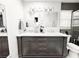 Modern bathroom featuring a double vanity with a marble countertop, ample storage, and decorative mirrors and lighting at 25640 State Road 70 E, Myakka City, FL 34251