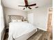 Bright bedroom features a neutral color scheme, ceiling fan, wood floors, and natural light at 25640 State Road 70 E, Myakka City, FL 34251