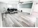 Spacious bedroom with modern decor, including a four-post bed, wood-look flooring, and neutral tones at 25640 State Road 70 E, Myakka City, FL 34251