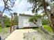 Exterior shot of a well-maintained gray shed featuring white trim, offering ample storage and outdoor space at 25640 State Road 70 E, Myakka City, FL 34251