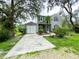 Charming two-story home featuring black shutters, well-maintained landscaping, and an attached garage at 25640 State Road 70 E, Myakka City, FL 34251