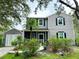 Charming two-story home featuring black shutters, well-maintained landscaping, and an attached garage at 25640 State Road 70 E, Myakka City, FL 34251