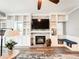 Living room featuring built-in shelving, a fireplace with stone surround, and a comfortable window seating nook at 25640 State Road 70 E, Myakka City, FL 34251
