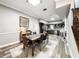 Spacious living room includes a dining room table, hardwood floors and a view of the modern kitchen at 25640 State Road 70 E, Myakka City, FL 34251