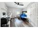 Comfortable office space with wood floors, bright natural light, floating shelves, and a modern blue couch at 25640 State Road 70 E, Myakka City, FL 34251