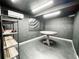 Dark interior with a round table, shelving and black walls at 25640 State Road 70 E, Myakka City, FL 34251