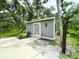 Outdoor shed on a lush green property with mature trees and access to a pond at 25640 State Road 70 E, Myakka City, FL 34251