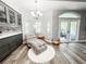 Bright sitting area features hardwood floors, a chaise lounge, and an exterior door to a patio at 25640 State Road 70 E, Myakka City, FL 34251