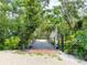 Charming walkway with brick accents and lush greenery, creating a serene and inviting path through the property at 25640 State Road 70 E, Myakka City, FL 34251