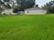 Large backyard features lush green grass and a metal shed at 328 20Th W St, Palmetto, FL 34221