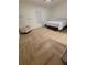 Cozy bedroom featuring herringbone floors, a comfortable chair, and a well-lit space at 328 20Th W St, Palmetto, FL 34221