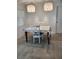 Dining room with a table set for two under modern hanging lights, complemented by bright natural light at 328 20Th W St, Palmetto, FL 34221