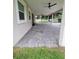 Angle shot of the home's exterior featuring brick pavers, manicured lawn and partially covered patio at 328 20Th W St, Palmetto, FL 34221