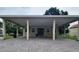 Charming single-story home with a large covered parking area and brick-paved driveway at 328 20Th W St, Palmetto, FL 34221