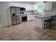 Modern kitchen features stainless steel appliances, granite counters, and stylish herringbone floors at 328 20Th W St, Palmetto, FL 34221