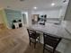 Modern kitchen features stainless steel appliances, granite counters, and stylish herringbone floors at 328 20Th W St, Palmetto, FL 34221