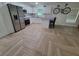 Modern kitchen features stainless steel appliances, granite counters, and stylish herringbone floors at 328 20Th W St, Palmetto, FL 34221