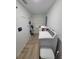 Laundry room includes a washer, storage, and herringbone-pattern tile flooring at 328 20Th W St, Palmetto, FL 34221
