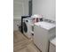 Laundry room featuring wood-look tile flooring and updated washer and dryer units at 328 20Th W St, Palmetto, FL 34221