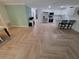 Open concept living space with modern kitchen, herringbone floors, and ample natural light at 328 20Th W St, Palmetto, FL 34221