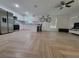 Open concept living space with modern kitchen, herringbone floors, and ample natural light at 328 20Th W St, Palmetto, FL 34221