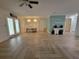 Spacious living room featuring modern herringbone floors, a dining area and light blue accent wall at 328 20Th W St, Palmetto, FL 34221