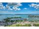 The aerial showcases the marina with sailboats and yachts, and blue sky with fluffy clouds at 33 S Palm Ave # 1501, Sarasota, FL 34236