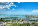 Stunning aerial view of the marina, coastline, and cityscape under a bright blue sky with fluffy clouds at 33 S Palm Ave # 1501, Sarasota, FL 34236