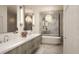 Luxury bathroom showcasing double sinks, modern fixtures, a crystal chandelier, and a soaking tub at 33 S Palm Ave # 1501, Sarasota, FL 34236