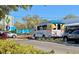 A view of the Bay Runner trolley parked along a street lined with lush plants and flowering trees at 33 S Palm Ave # 1501, Sarasota, FL 34236