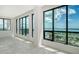 Bright living room with floor-to-ceiling windows and stunning views of the marina and ocean at 33 S Palm Ave # 1501, Sarasota, FL 34236