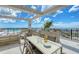 Beautiful rooftop terrace with a built-in outdoor kitchen, dining area, and stunning water views at 33 S Palm Ave # 1501, Sarasota, FL 34236