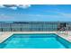 A pristine swimming pool boasts views of the horizon beyond a sleek, black metal safety fence at 33 S Palm Ave # 1501, Sarasota, FL 34236