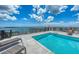 Rooftop pool with lounge chairs and a view of the city and ocean on a sunny day at 33 S Palm Ave # 1501, Sarasota, FL 34236