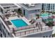 Inviting rooftop pool with lounge chairs, surrounded by a secure fence and city views at 33 S Palm Ave # 1501, Sarasota, FL 34236