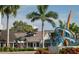 Exterior view of Florida Studio Theatre featuring a modern sculpture with lush landscaping on a sunny day at 33 S Palm Ave # 1501, Sarasota, FL 34236